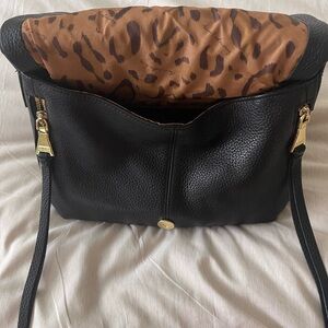 Black and gold convertible shoulder bag.